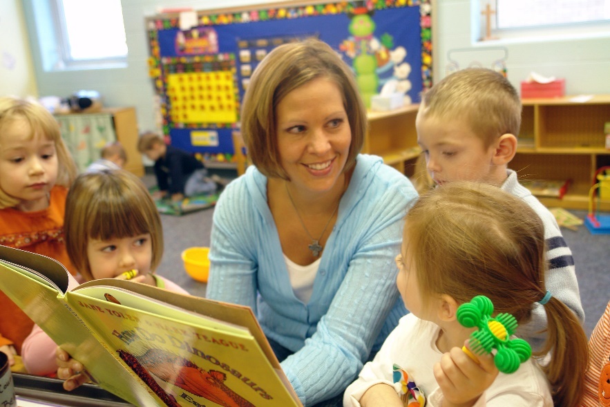photo of a teacher reading to children